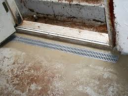 A french drain removes water from a basement by collecting moisture in a shallow trench, pulling it into a perforated pipe, and expelling it to a basin and sump pump. Grated Drainage Pipe System In Lexington Covington Fort Mitchell Drainage System In Kentucky