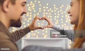 Male Prisoner Sharing Love With Wife In Prison Visit Room Stock Photo