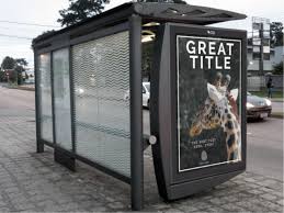 An informational banner template inside of a stop of city transport on the sidewalk; Free Bus Stop Advertising Mockup Download Psddaddy Com