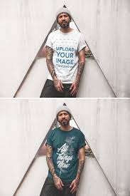 Tattooed Man Wearing A T Shirt Mockup While Lying Against A Triangle Structure