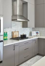 Gray Flat Front Kitchen Cabinetry Sets A Clean Classy Neutral Base Added By A Collection Of Pastel Cool Color From Ca Kitchen Design Kitchen Mosaic Backsplash