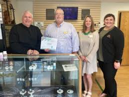 CROOKSTON CHAMBER AMBASSADORS STOP AT CANNA CORNERS TO CONGRATULATE AND  CELEBRATE WITH JOHN REITMEIER