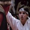 Karate definition, a method developed in japan of defending oneself without the use of weapons by striking sensitive areas on an attacker's body with the hands, elbows, knees, or feet. 1
