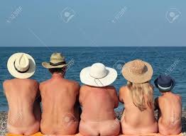 Naked Family In Hats Sitting On The Beach Stock Photo, Picture and Royalty  Free Image. Image 62152733.