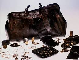 This leather Gladstone bag was found with many items from the purser's safe  in the debris field. Among the items were necklaces, watches, keys, and  other valuables and personal effects. The contents