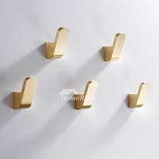 The collection includes a towel ring, freestanding rail, wall hook and wall mounted frame. Gold Luxury Brushed Brass Wall Coat Hooks Vintage Bathroom Robe Hook
