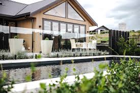 A pool house design presents bathers a location to change, clean up, and get a snack as well as a drink. Pool Fencing Glass Aluminium Auckland Whangarei