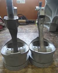 It features a 4.6 liter ford mustang modular engine block as it's base with the cylinder pistons welded in place to hold up a clear glass coffee table top. V8 Engine Block Coffee Table Hometalk