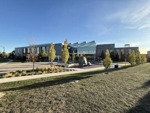 Community building near green trees, reflecting Cornell's central amenities and recreation centre