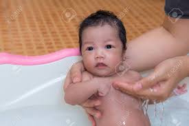 How do i give my newborn her first bath at home? Newborn Baby Taking A Bath By Mother At Home Asian Child Stock Photo Picture And Royalty Free Image Image 48391538