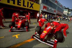Eddie Irvine Of Great Britain And Michael Schumacher Of Germany And Ferrari Leave The Team Garage Before The For Japanese Grand Prix Germany Michael Schumacher