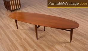 Dowel legs and an oval top give the coffee table the silhouette of authentic pieces from the 1950s and '60s. Sleek Oval Mid Century Modern Coffee Table