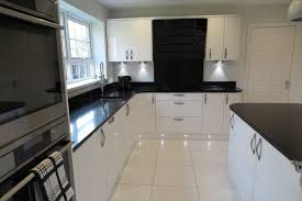 This is the greenwich gloss kitchen in white by howdens. White Kitchen Grey Tiles Black Worktop Novocom Top