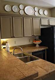 The wall next to the front door. How To Decorate Above Kitchen Cabinets 20 Ideas Kitchen Soffit Kitchen Cabinets Decor Decorating Above Kitchen Cabinets