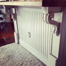 Beautiful kitchen with cabinet front two door refrigerator across from large beadboard paneled island with stainless steel griddle cook top framed by gray stone countertops. Diy Beadboard Kitchen Island With Corbels