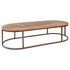 An oval coffee table with a glass top will keep the room feeling light and airy, while those made of thick slabs of marble or concrete will command more attention. Tilton Rustic Lodge Reclaimed Wood Iron Oval Coffee Table 61 W Over Kathy Kuo Home