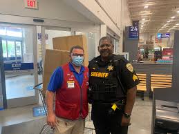 The sign has this door must remain unlocked during business hours text in bold white, against a reflective black background. Lowes 2591 2591lowes Twitter