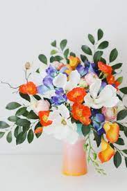 With exquisite artificial flower arrangements in shades of white, pink and red, floral bouquets and twigs lend a fresh touch to your room. Artificial Vs Real Flowers For Your Wedding Orange And Blue Flowers In Fake Flower Arrangements Fake Flowers Flower Arrangements