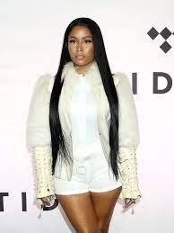 A vulgar disgusting stripper and thief. Nicki Minaj Flaunts Long Black Hair At Tidal X 1015