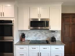 Closeup of shaker style doors refinished to a custom white. Project Gallery Top Shelf