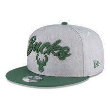 This cap features a polyester crown, custom logo'd fabric visor and button, black snapback, 3d metal 50th anniversary logo and inside this cap, the our exclusive 50th anniversary headwear collection celebrates the bucks entire history in one cap, featuring a collage of all era logos woven into the fabric. Milwaukee Bucks Nba Draft Grey 9fifty Cap New Era Cap