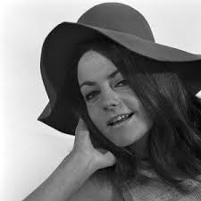 Image of Ann Cave, model, poses with a make up mask, 29th