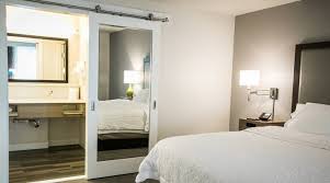 But the sliding barn door is not just about its looks alone. Hampton Inn Mirror Inlay Sliding Barn Door For Bathroom And Closet Forest Bright Architectural Wood Doors