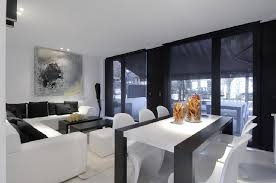 The kitchen, dining room and living room are beautifully distinguished by placing large jute chenille rugs in the center of each area while wood is used as a common material in the three spaces to merge them cohesively. Living Room Dining Room Modern Interior Design Ideas