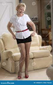 Elderly Woman Standing in a Short Skirt Stock Image - Image of room, shirt:  112660473
