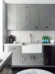 Gray and white cabinets, marble subway tile, carrara countertops, a farmhouse sink, and brass hardware give this marble kitchen a classic yet modern look. 20 Stylish Ways To Work With Gray Kitchen Cabinets Contemporary Kitchen Cabinets Kitchen Cabinet Design Contemporary Kitchen