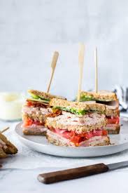 Cover with a slice of toast, then the bacon and tomato. The Ultimate Turkey Club Sandwich Recipe Simply Whisked