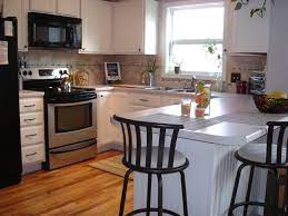 It helps the new layer of paint bond with the previous layer and the primer to make a more even coat. Tutorial Painting Fake Wood Kitchen Cabinets Painting Kitchen Cabinets White Small White Kitchens Wood Kitchen Cabinets