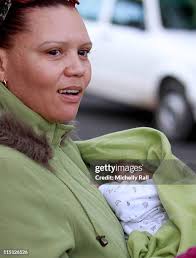 Jenny Berger and Dean Berger carry babies outside the Building Blocks...  News Photo