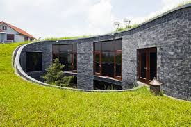 White farm house wooden candle lantern. Vo Trong Nghia S Modern Blue Stone House Sports A Rising Green Roof In Viet Nam