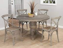The dining table is constructed of paulownia veneers in a gray finish with a gray metal base with black hand brush accents. Weathered Driftwood Grey Dining Table X Back Chairs Distressed Wood Reclaimed Wood Jofra Round Pedestal Dining Table Round Pedestal Dining Wood Dining Room Set