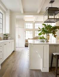 White Kitchen With A Mix Of Modern And Traditional Details The Stepped Column At The End Of The Is Home Kitchens Off White Kitchens Off White Kitchen Cabinets