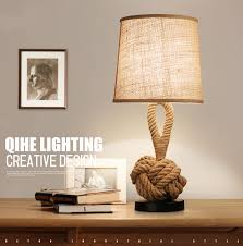 Light up your living room with a bold geometric lamp featuring a gold base and a white lamp shade for contrast. Modern Led Table Lamp Linen Hemp Rope Creative Hallway Bedroom Decor Horizon Lights