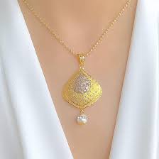 One of the materials listed is lead, and because most light fixtures contain brass in the sockets or in the frames of the shades, we are required to put this warning label on our light fixtures. Lightweight Two Tone Gold Pendant Set Andaaz Jewelers