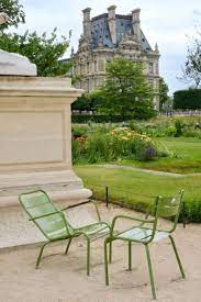green chairs in paris with the musee du louvre paris with landen tuileries garden paris garden france aesthetic