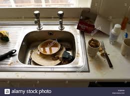 a dirty kitchen sink in an old man s