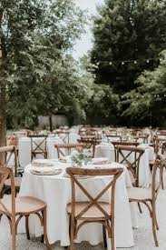 Quaint And Delicately Decorated Reception With Rustic Cross Back Chairs Outdoor Wedding Tables Garden Wedding Reception Decorations Outdoor Wedding Reception