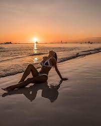 Yoga people training and meditating in warrior pose outside by beach at sunrise or sunset. 48 Flattering Bikini Beach Poses To Try This Spring Sharp Aspirant