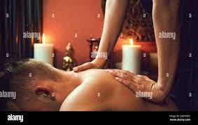 Asian woman doing Thai massage to adult man at spa salon Stock Photo - Alamy
