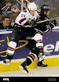 Vancouver Canucks' Tyler Bouck, left, hits the Edmonton Oilers' Steve  Staios, during the second period of NHL preseason hockey action, at  Edmonton's Rexall Place