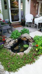 The Url Didn T Work For This But Pinning Because I Like The Nasturtiums Around The Pond Small Backyard Ponds Waterfalls Backyard Ponds Backyard