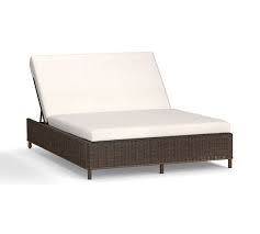 After deciding which outdoor chaise lounge chairs meet your needs, line up a row of them beside the pool to give the backyard a resort feel. Torrey All Weather Wicker Double Outdoor Chaise Lounge Pottery Barn