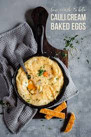 Creamy Baked Cauliflower Mash Topped With Parmesan And With A Runny Egg Yolk Surprise This Is Such A D Low Carb Breakfast Recipes Baked Cauliflower Baked Eggs