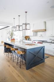 It has two pendant lights hanging on a wood beam ceiling and an island table with white wooden cabinets. 75 Beautiful Farmhouse Kitchen Design Ideas Pictures Houzz