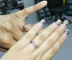 What can be better than a wedding ring tattoo to make the biggest and the most memorable milestone of your life permanent? 48 Sweet Wedding Ring Tattoos Ring Tattoo Designs Ring Finger Tattoos Wedding Finger Tattoos