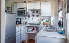 In the picture above this small kitchen with white cabinets gets creative with fun blackboard cabinet doors. How Can I Organize My Small Kitchen